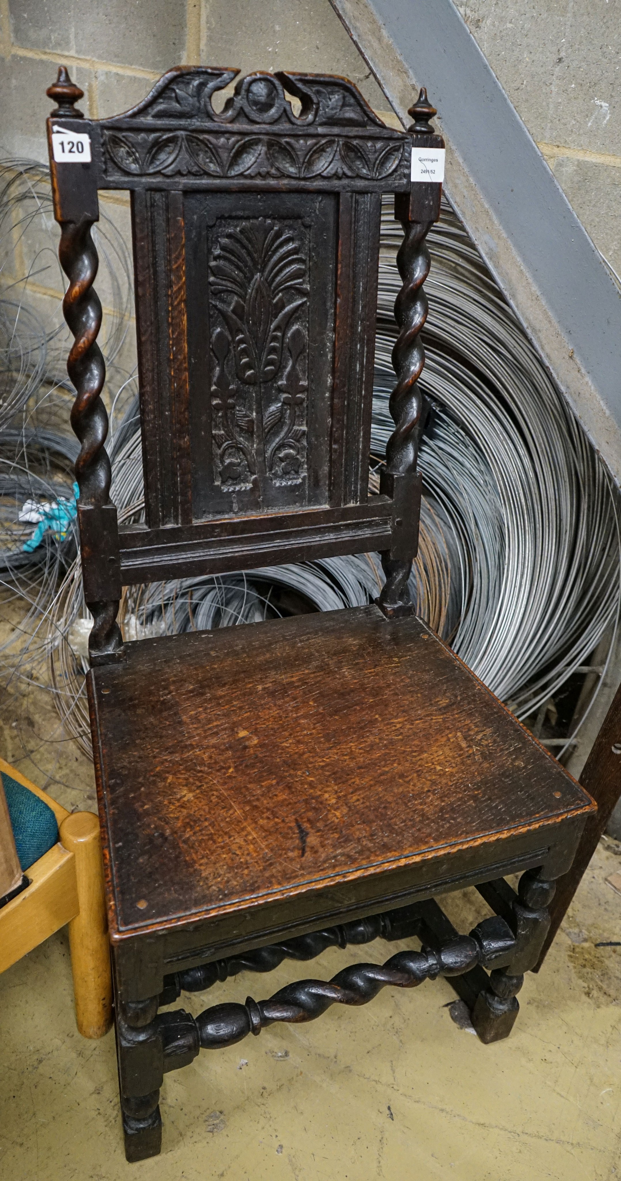 A 17th century oak dining chair, with carved panelled back, solid seat and barley twist stretchers, width 49cm, depth 39cm, height 96cm